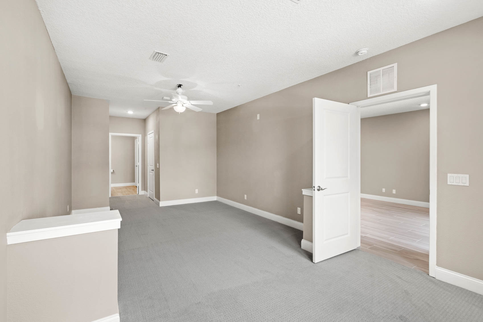bedroom with open door and sitting space